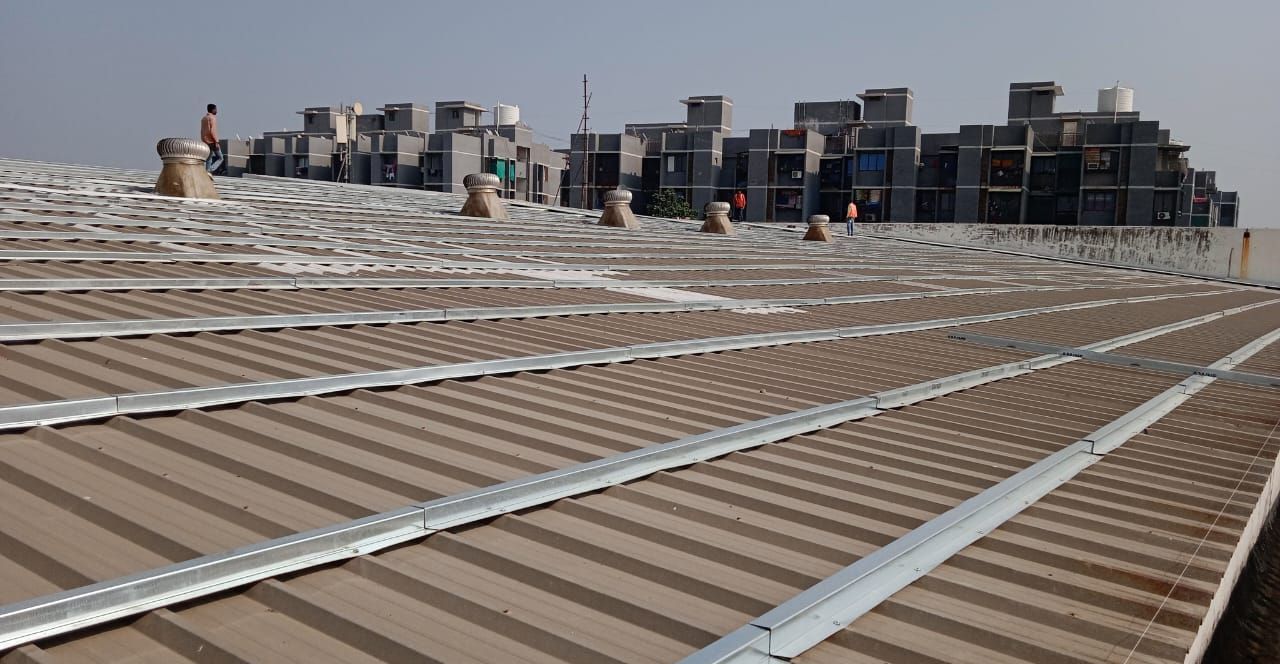 Galvanised sub-framing fixed in rows across an existing corrugated roof with turbo ventilators