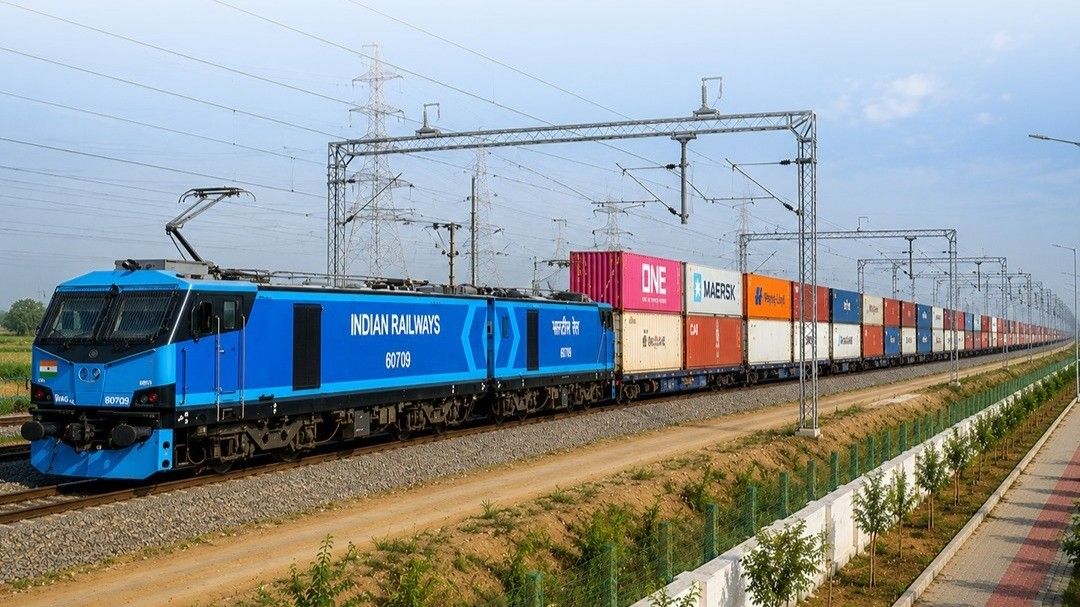 Electric locomotive hauling a double-stack container train under overhead wires on the Dedicated Freight Corridor