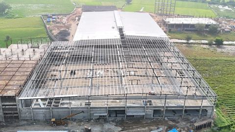 Aerial view of a pre-engineered building with roof sheeting partly installed